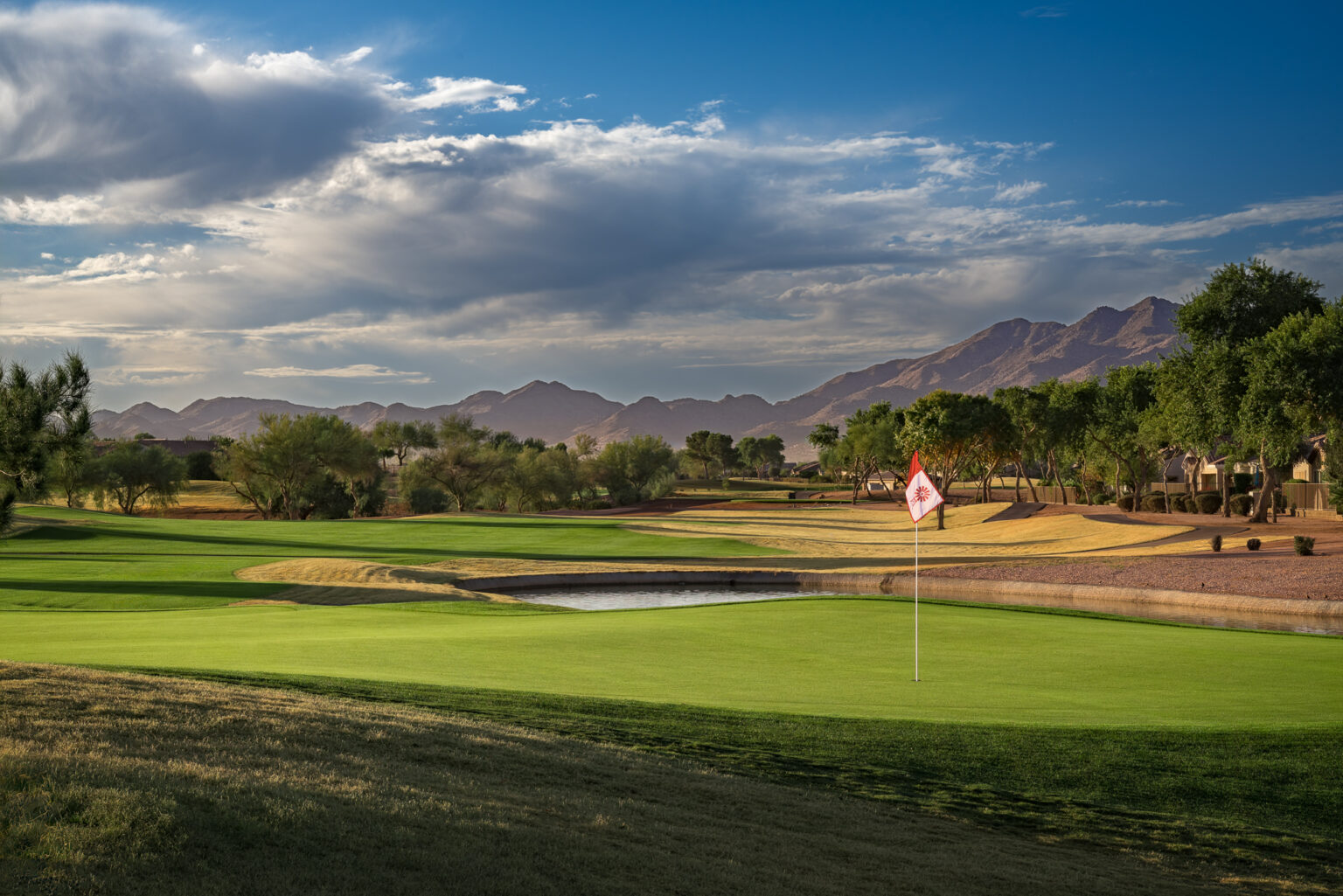 Power Ranch Golf Club green with flagstick and the San Tan Mountains behind, Gilbert Arizona