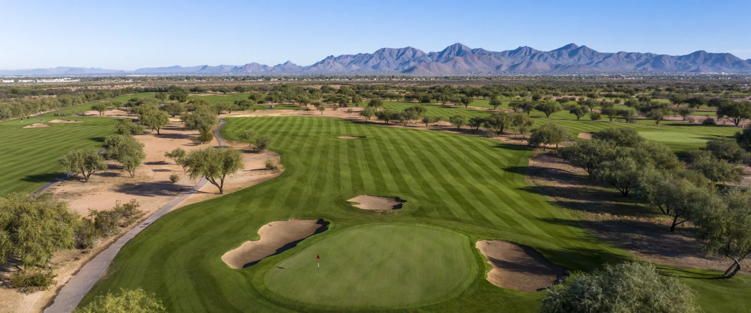 Striped fairway and bunkered green on the O'odham Course at Talking Stick Golf Club with the McDowell Mountains behind, Scottsdale Arizona