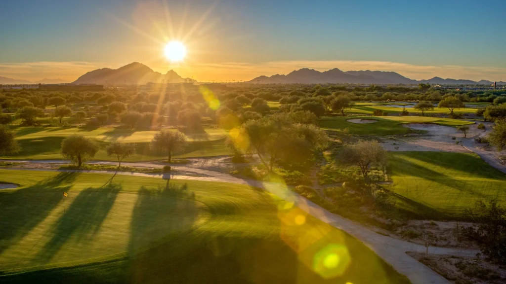 Sunrise over hole 7 on the O'odham Course at Talking Stick Golf Club with the McDowell Mountains behind