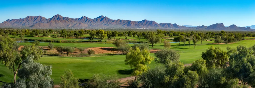 Panorama of hole 17 on the Piipaash Course at Talking Stick Golf Club with the McDowell Mountains on the horizon