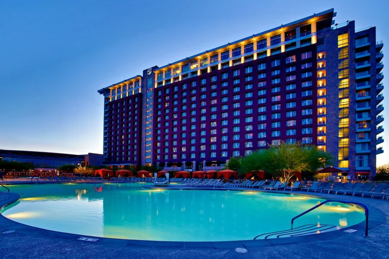 Talking Stick Resort tower above the pool at dusk